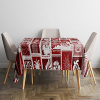 Red patchwork tablecloth with white geometric holiday squares on square table