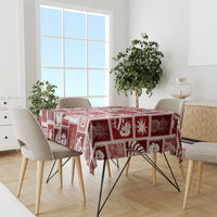 Red patchwork holiday tablecloth with white motif squares on dining table