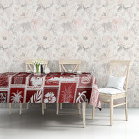 Red patchwork tablecloth with white holiday icons covering long dining table