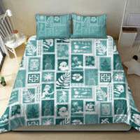 Teal patchwork bedding set laid flat on bed with tropical square motif