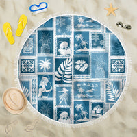 Round aquamarine patchwork beach blanket with white fringe border and tropical print
