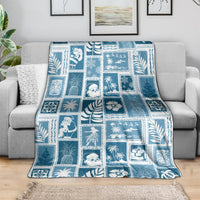 Blue-and-white patchwork throw blanket in aquamarine tones with holiday and tropical squares