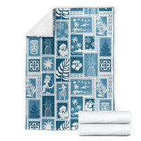 Aquamarine patchwork blanket laid flat with blue-and-white holiday and tropical block designs