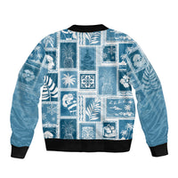 Aquamarine patchwork bomber jacket with black ribbed cuffs and all-over festive graphic print