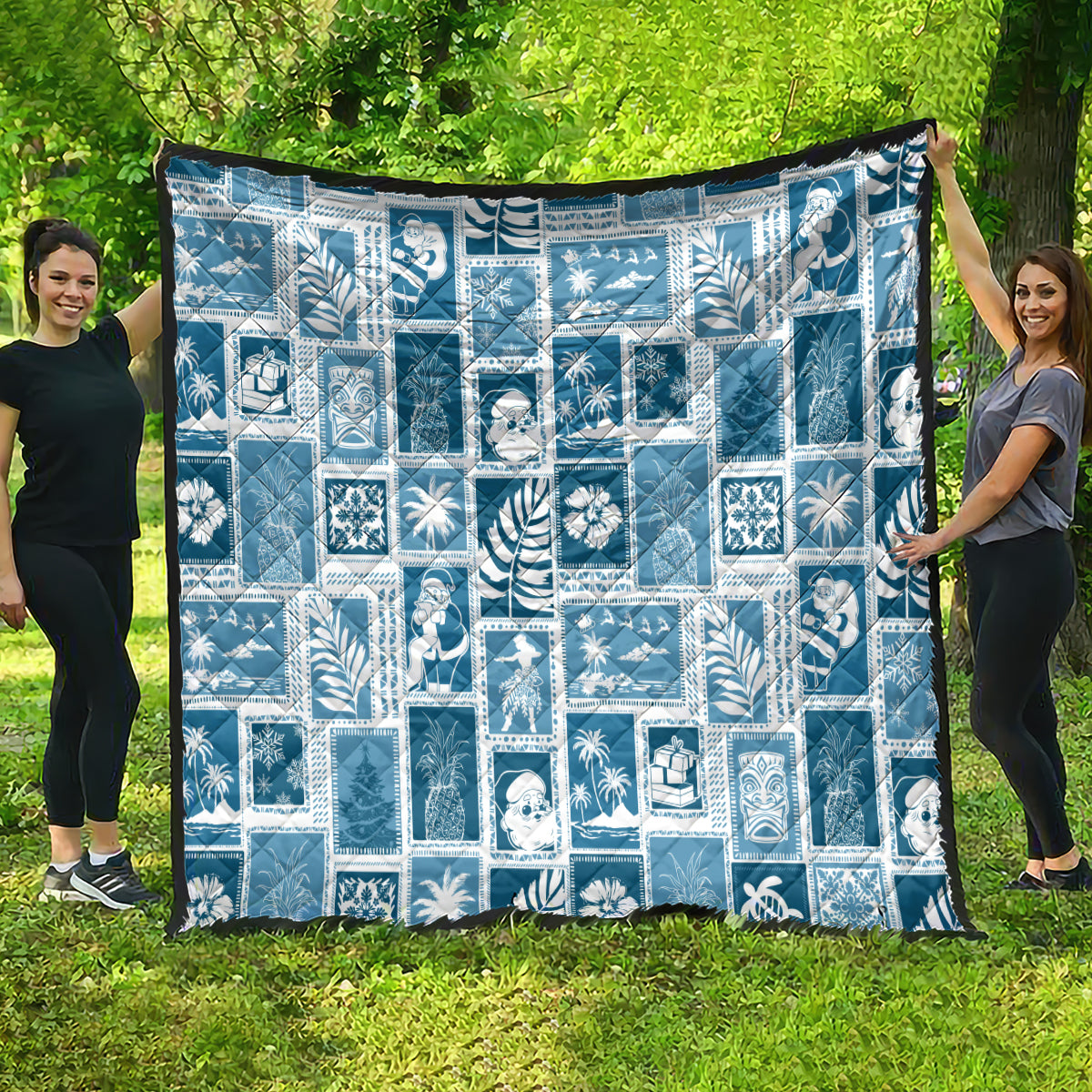 Aquamarine patchwork quilt draped outdoors, white holiday-themed block pattern with trim.