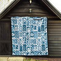 Aquamarine quilt hanging in wooden shed, white patchwork grid and stitched edge border.