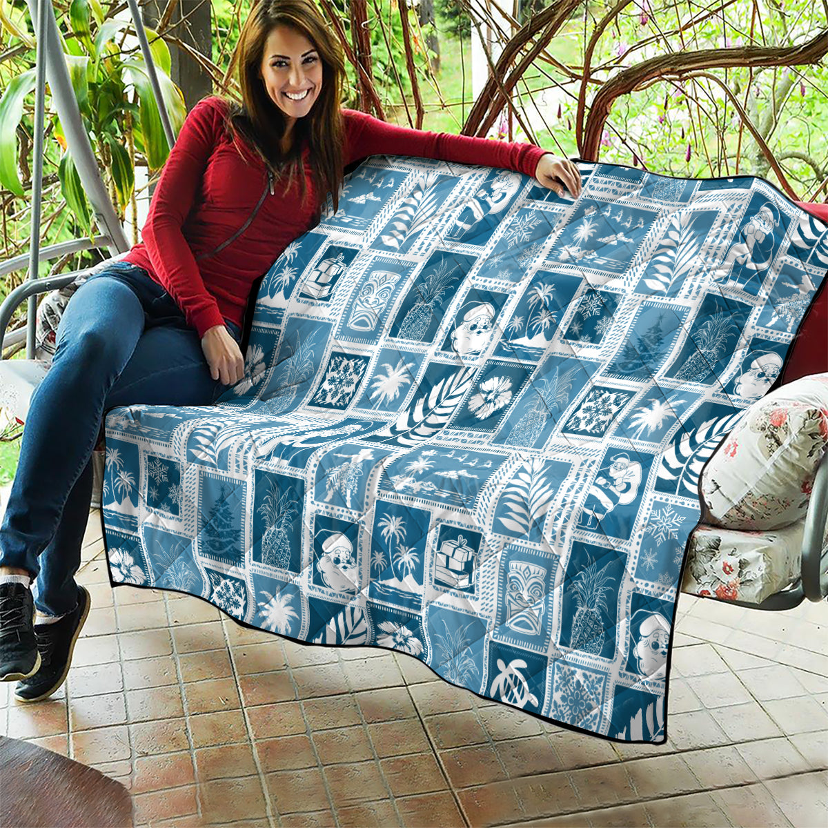 Aquamarine quilt on outdoor seating, white holiday block pattern with stitched edges.