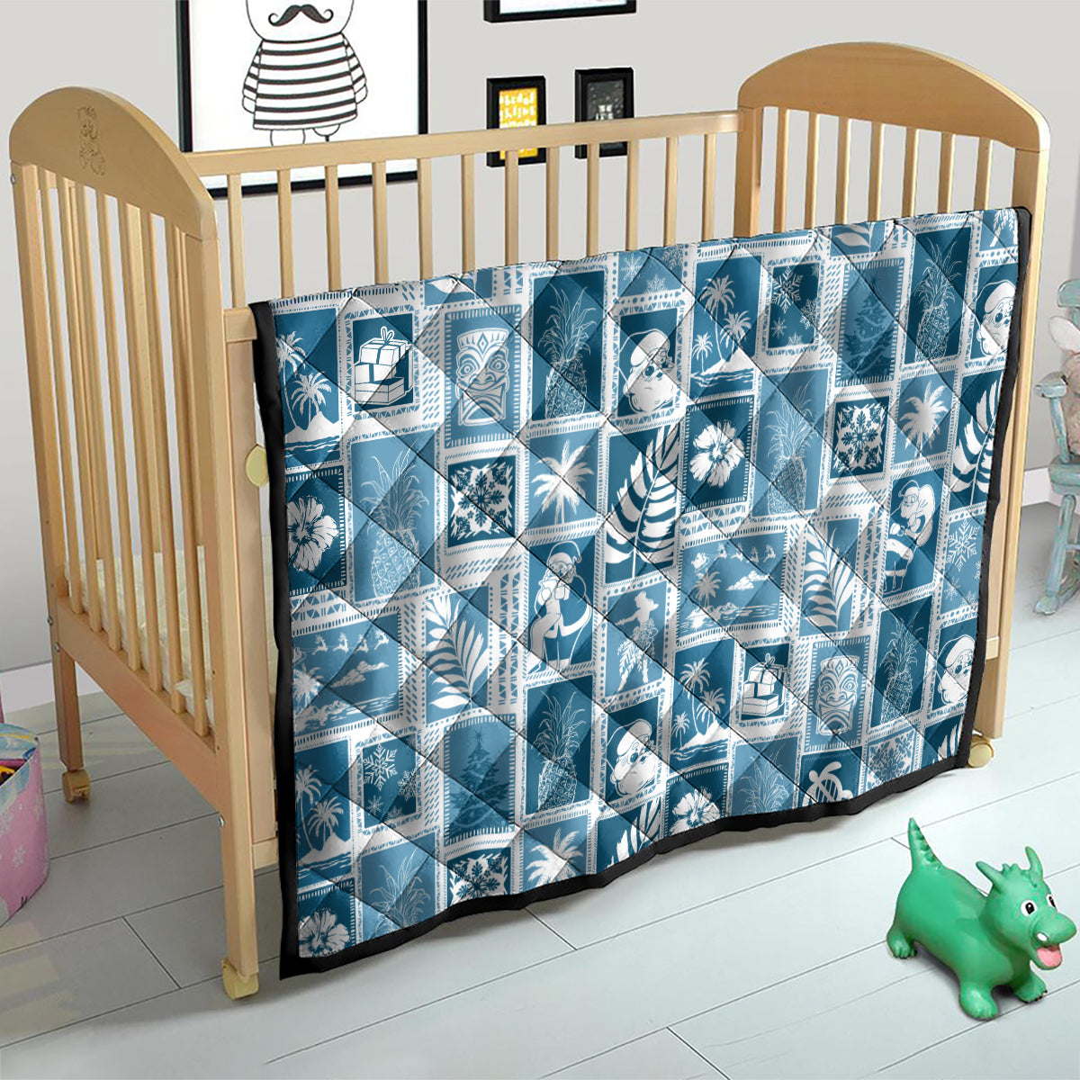 Aquamarine patchwork quilt on baby bed, white holiday block pattern with black edge trim.