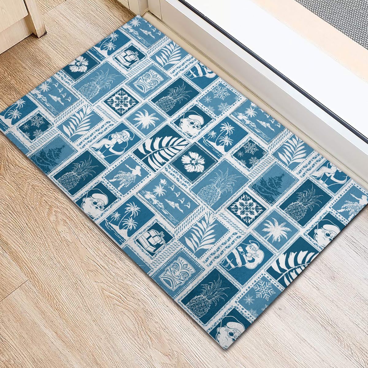 Aquamarine rubber doormat featuring bordered patchwork icons and palm-themed motifs
