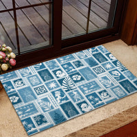 Aquamarine rubber doormat with square patch design of holiday figures, leaves, and trees