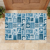 Aquamarine rubber doormat with full-bleed patchwork of snowflakes, palms, and holiday icons