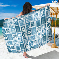 Aquamarine blue patchwork sarong with white tropical graphic squares, draped