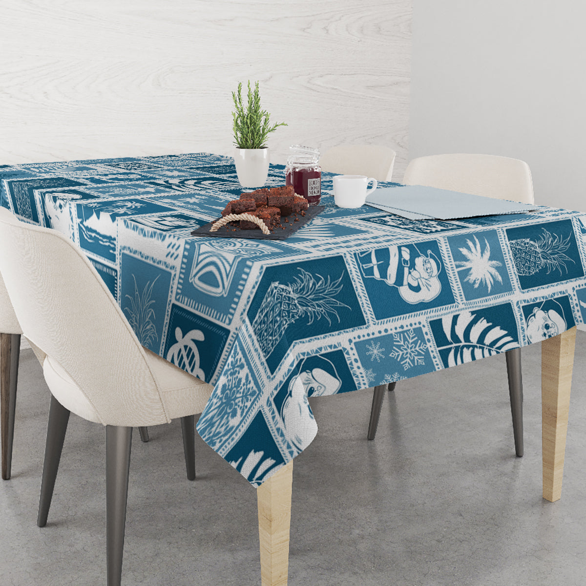 Aquamarine blue patchwork tablecloth with framed tropical motifs and white accents