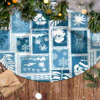Aquamarine patchwork Christmas tree skirt with snowflake and palm themed blocks.