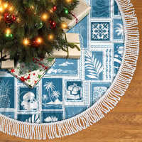 Aquamarine patchwork Christmas tree skirt with white braided fringe trim and ornaments.
