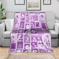 Violet patchwork Christmas blanket with patterned square blocks, draped on a couch