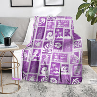Violet patchwork Christmas blanket with festive tile pattern, spread on a living room couch