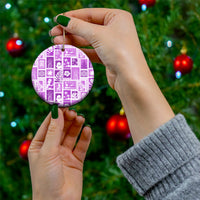 Violet ceramic round ornament in hand on a Christmas tree, gold hanging loop and patchwork.