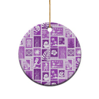 Violet ceramic round ornament with retro patchwork print and gold hanging loop on top.
