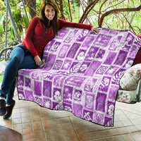 Violet Hawaiian patchwork quilt draped on a couch, white leaf and figure prints