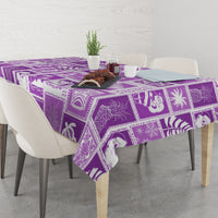 Violet rectangular tablecloth with geometric patchwork border and tropical prints.