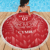 Red round beach blanket with white fringe, dragon crest, CYMRU and '07' centered