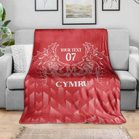 Red personalized rugby blanket draped with white dragon crest and 'YOUR TEXT 07' 'CYMRU'