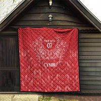 Red quilt hung on wall with black border edge, white dragon crest and 'Your Text 07' CYMRU