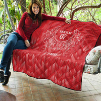 Red quilt draped on patio seating with diamond quilting and white dragon emblem, 'Your Text 07' CYMRU
