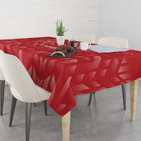 Red tablecloth with geometric pattern, draped over square dining table