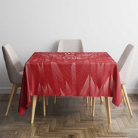 Red tablecloth with geometric pattern on dining table with four chairs