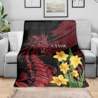 Dragon and daffodil throw blanket on sofa, black with red dragon and yellow daffodils
