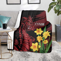 Dragon and daffodil blanket on floor, black with red dragon, yellow daffodils and Cymru lettering