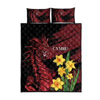 Black quilt and pillowcases with red dragon artwork and yellow daffodils, top view