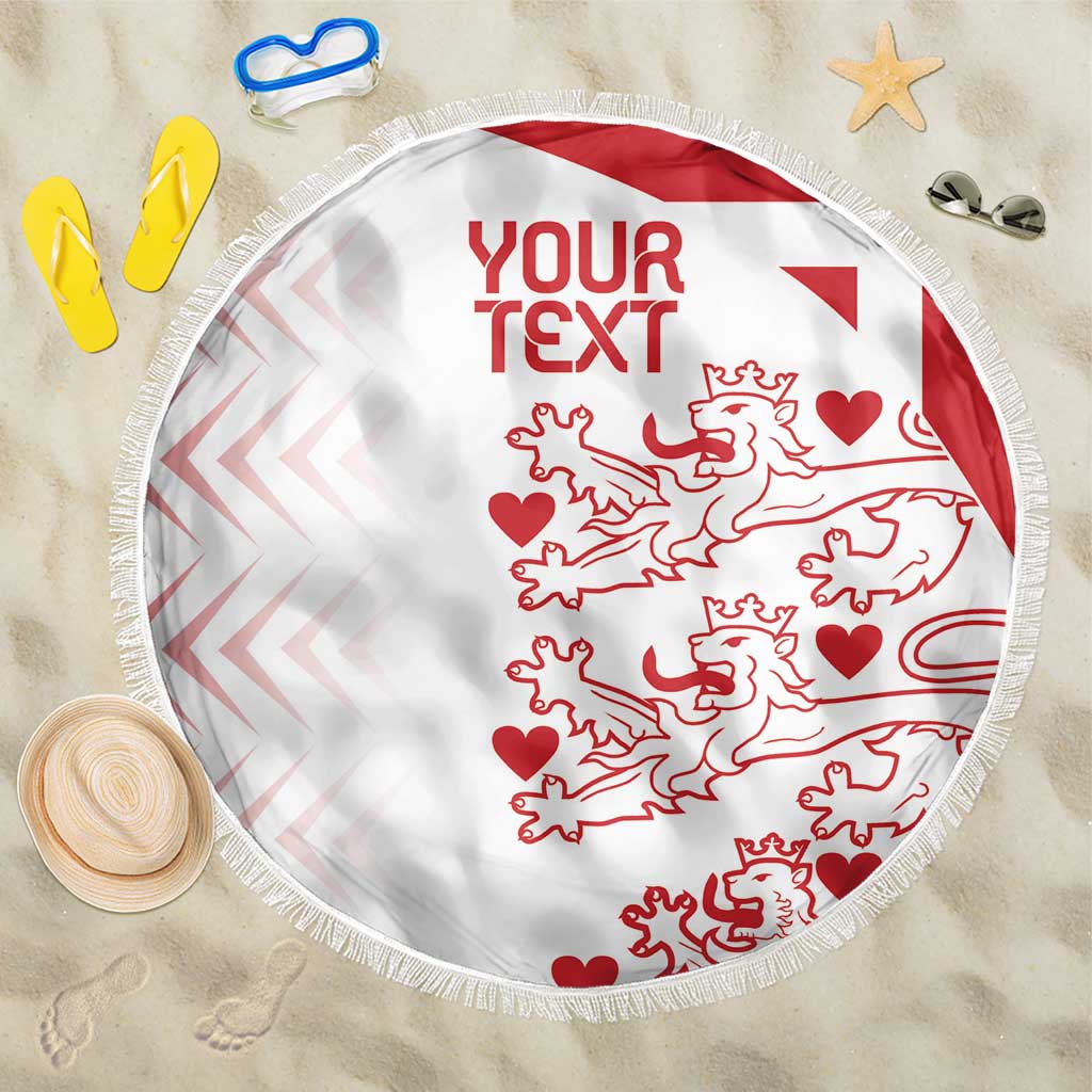 White round beach blanket with red custom text, lion pattern, and fringed border