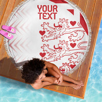 White round beach blanket with red custom text and lion hearts motif, fringed edge