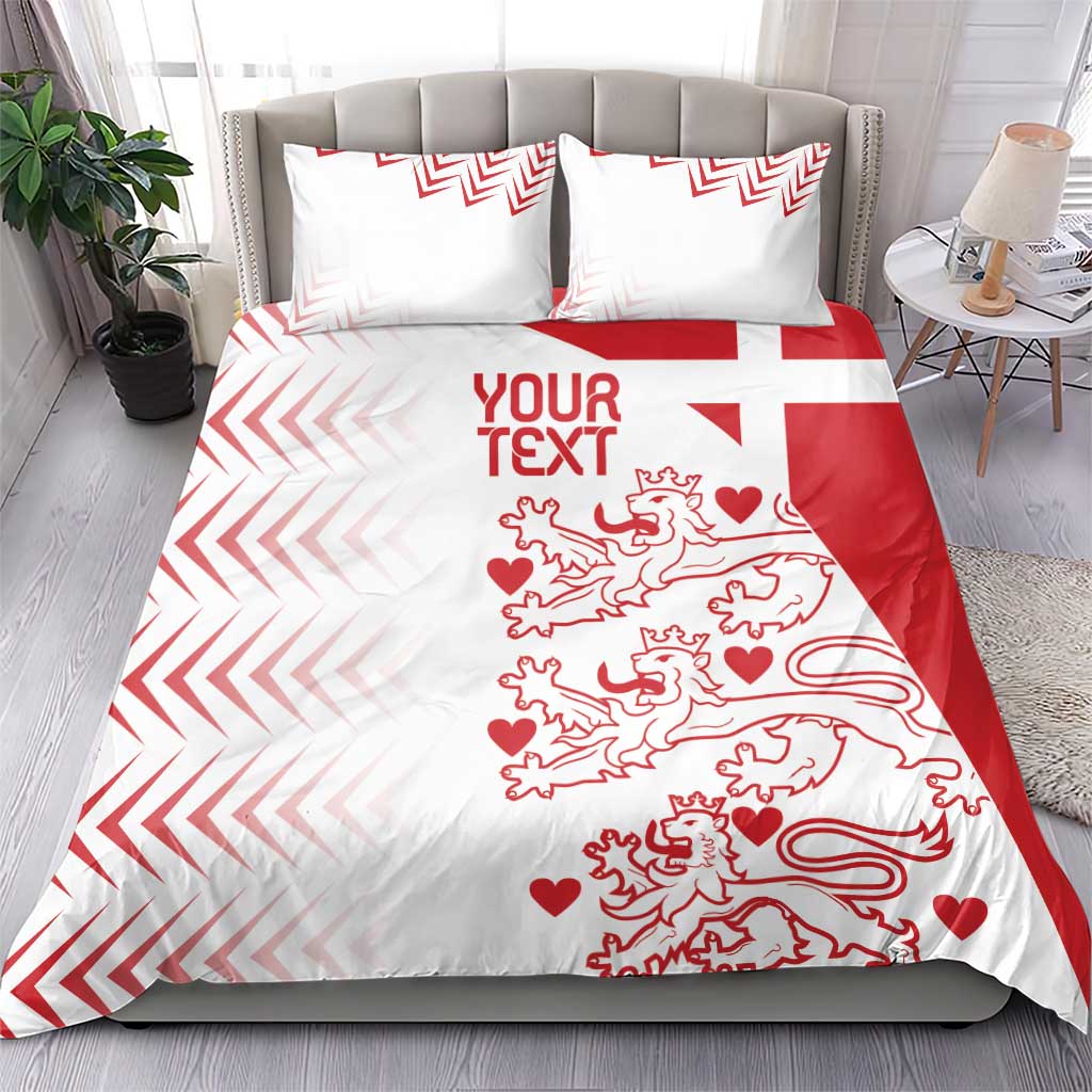 White and red bedding set on bed with two pillow shams; chevrons and lion hearts print