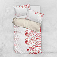White bedding set with red lion-and-heart print and chevron accents, including two shams