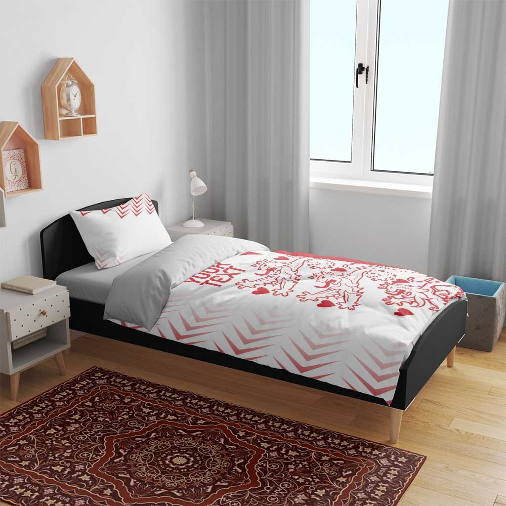 White and red duvet cover set on bed with two pillow shams, chevrons and lion hearts