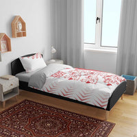 White and red duvet cover set on bed with two pillow shams, chevrons and lion hearts