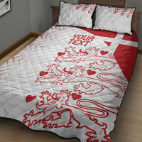 White and red quilt bed set with centered crest and hearts pattern