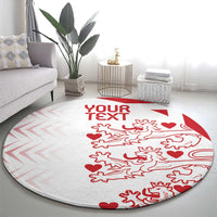 Round carpet in living room, light gray with red 'YOUR TEXT' and lions hearts motif