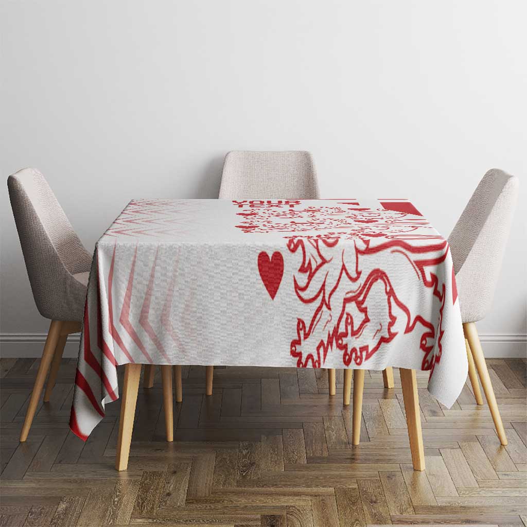 Red and white patterned tablecloth covering a dining table with chair sides