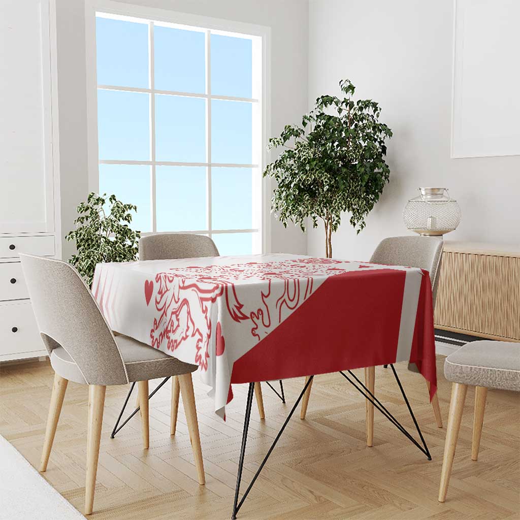 Red and white pattern tablecloth on dining table with five chairs