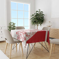 Red and white pattern tablecloth on dining table with five chairs