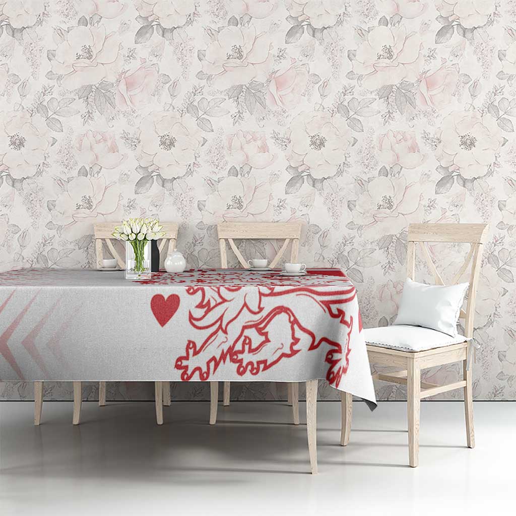 Red and white crest heart tablecloth on a long dining table