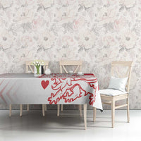 Red and white crest heart tablecloth on a long dining table