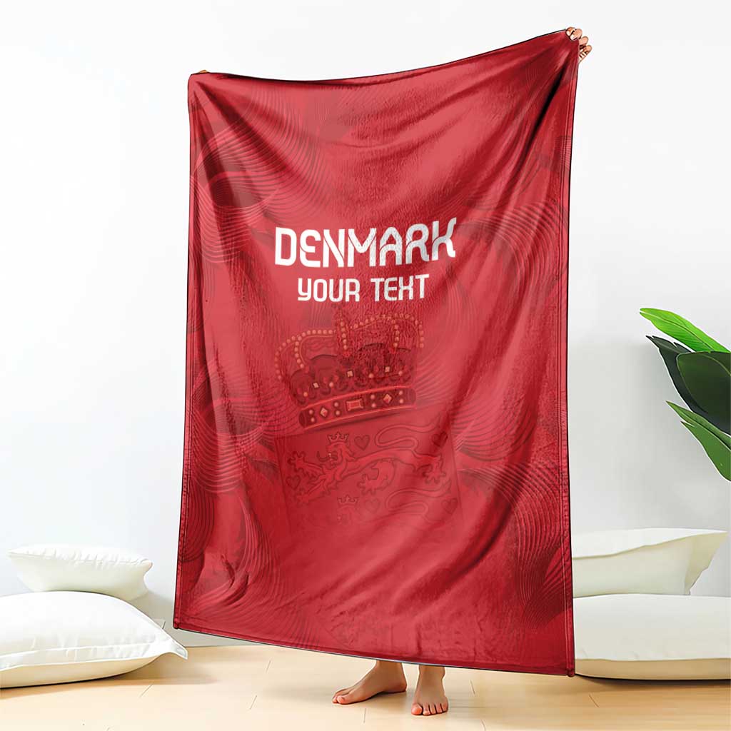 Red football blanket with white DENMARK YOUR TEXT and crest, hanging over a cushion