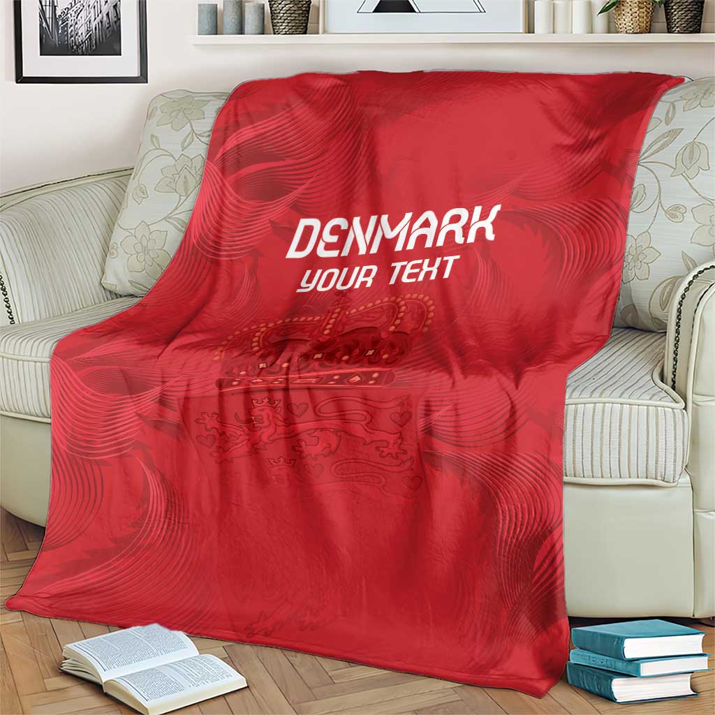 Red football blanket covering sofa with white DENMARK YOUR TEXT and crown crest artwork