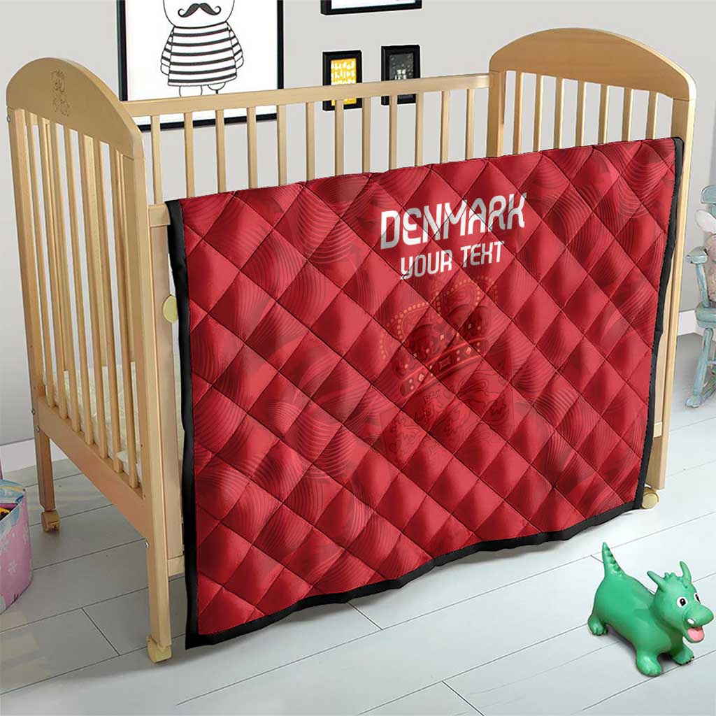 Red quilt on a wooden baby bed frame, diamond quilting, 'DENMARK' and 'YOUR TEXT'